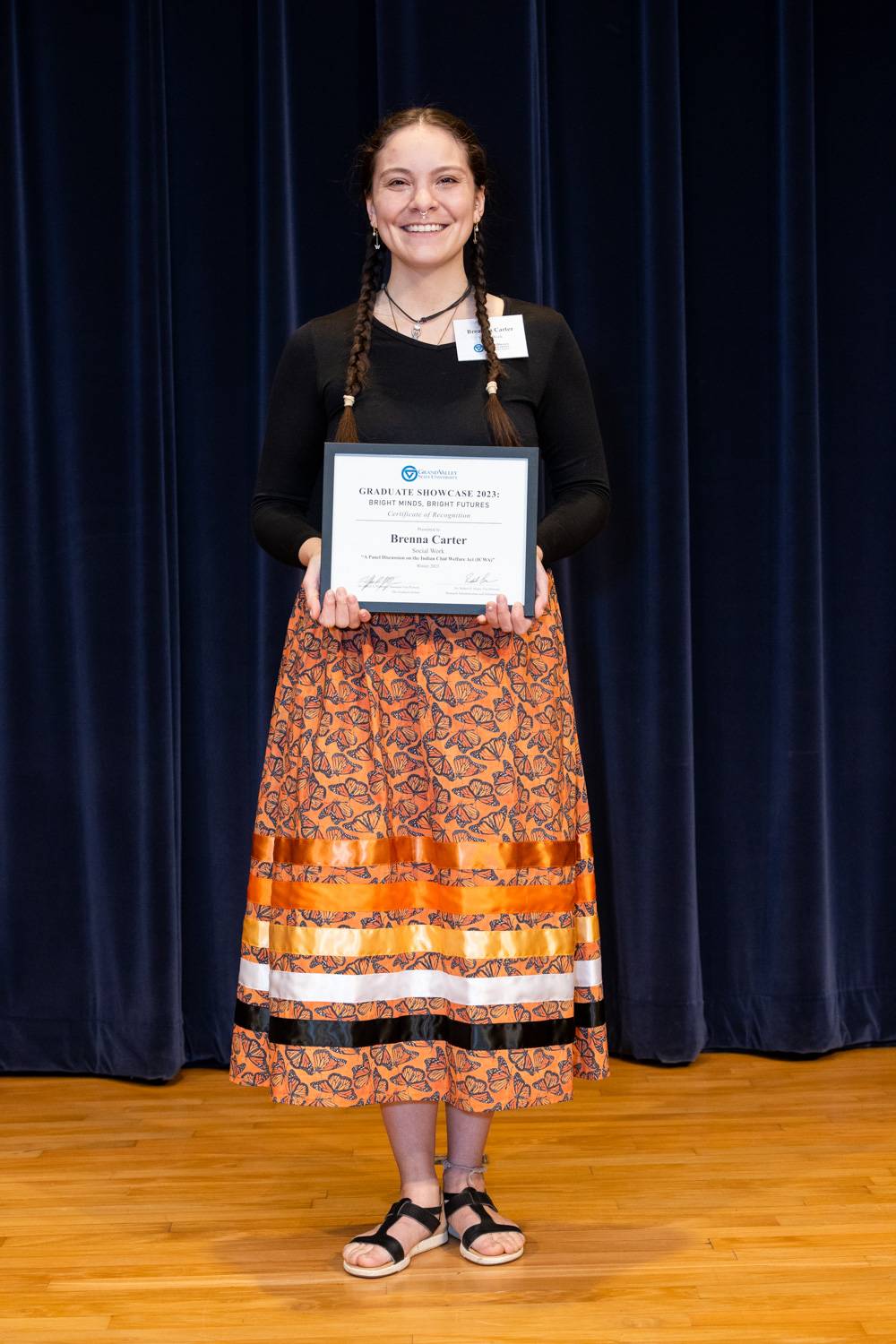2023 Graduate Showcase participant, Breanna, holding her certificate.